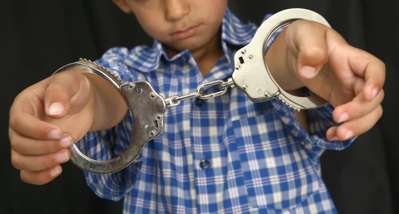 kid in hand-cuffs