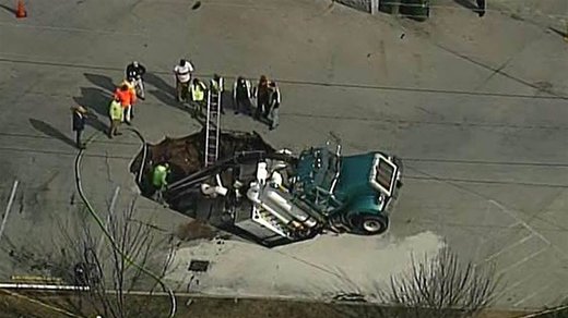 Excavation truck falls into sinkhole
