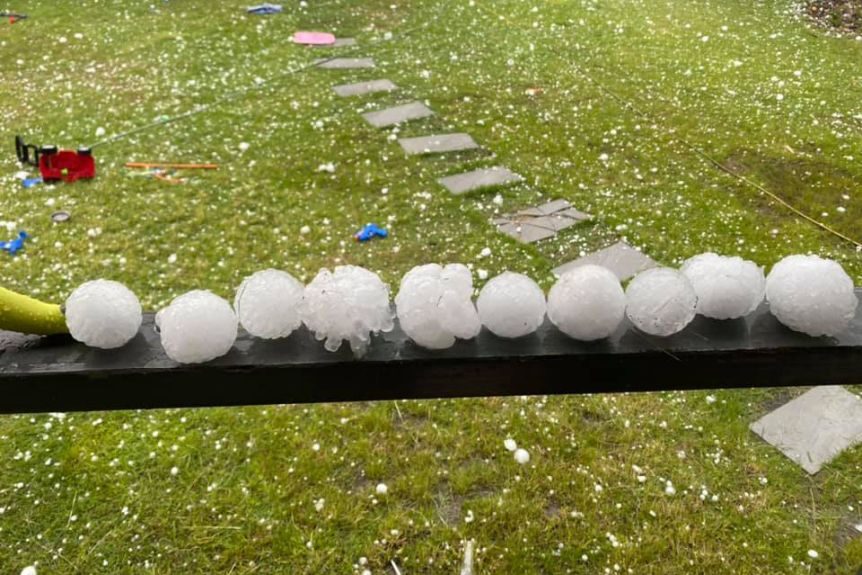 Huge hail stones lined up on a handrail at a house at Willowbank, west of Brisbane